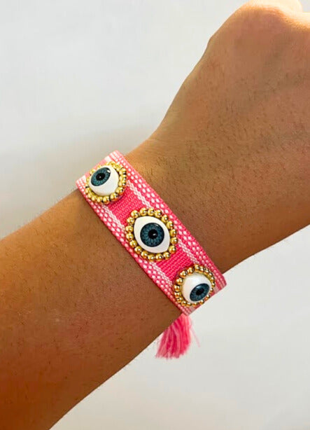 PULSERA TEJIDA TRES OJOS FUCSIA