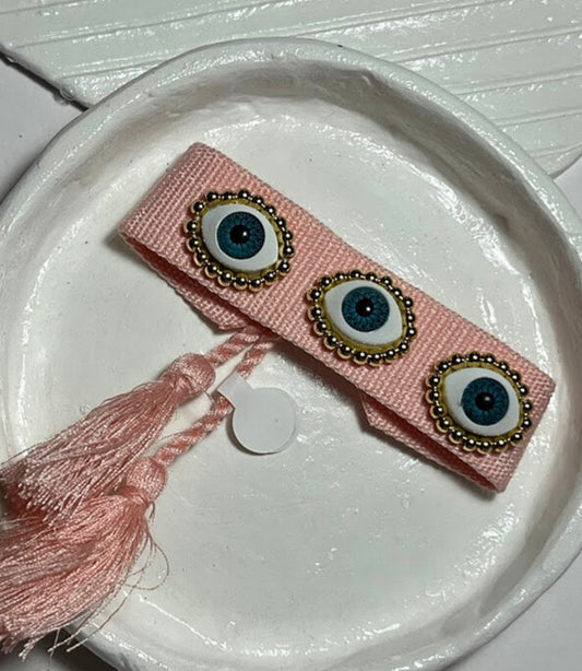 PULSERA TEJIDA TRES OJOS ROSA